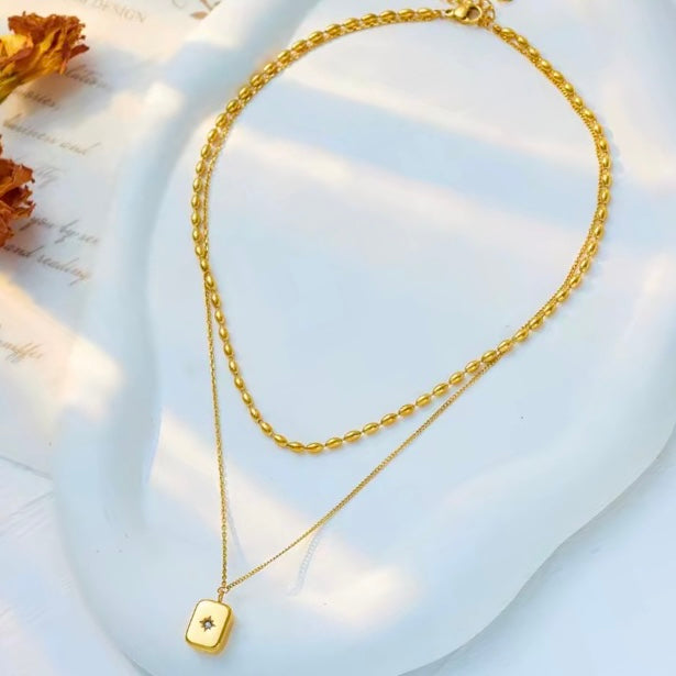 Gold double layer necklace with zirconia inlaid pendant