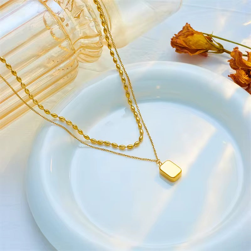 Gold double layer necklace with zirconia inlaid pendant